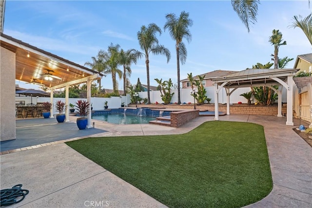 view of pool featuring a patio area, a fenced backyard, a lawn, and a gazebo