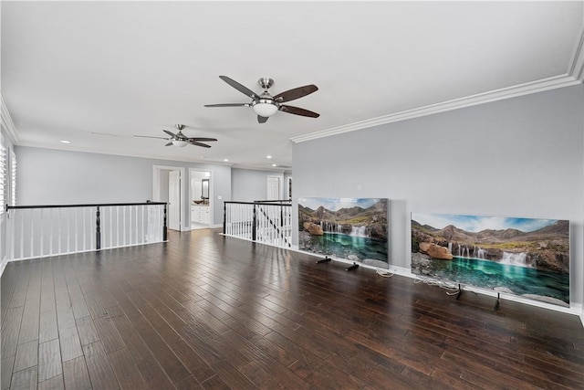 unfurnished living room featuring ornamental molding and wood finished floors