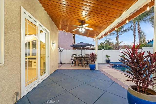 view of patio featuring a fenced backyard, ceiling fan, and a fenced in pool