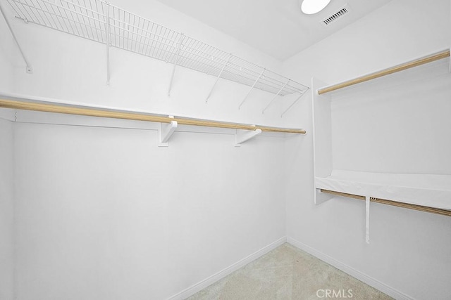 walk in closet with light carpet and visible vents