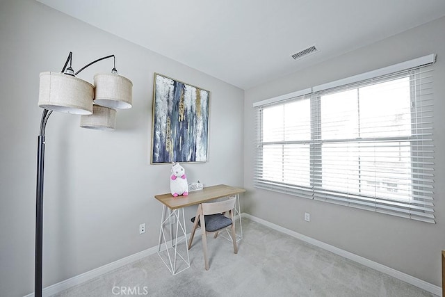 office space with light colored carpet, visible vents, and baseboards