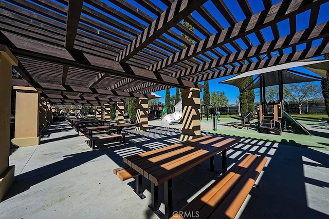 view of patio / terrace featuring playground community and a pergola