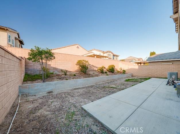 view of yard with a patio area and a fenced backyard