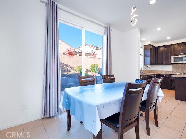 dining space featuring recessed lighting, baseboards, and light tile patterned floors