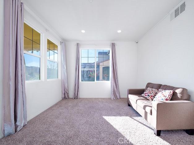 living room featuring visible vents, carpet flooring, and recessed lighting