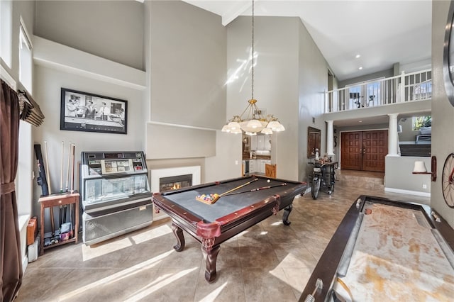 recreation room with recessed lighting, billiards, a towering ceiling, a glass covered fireplace, and ornate columns