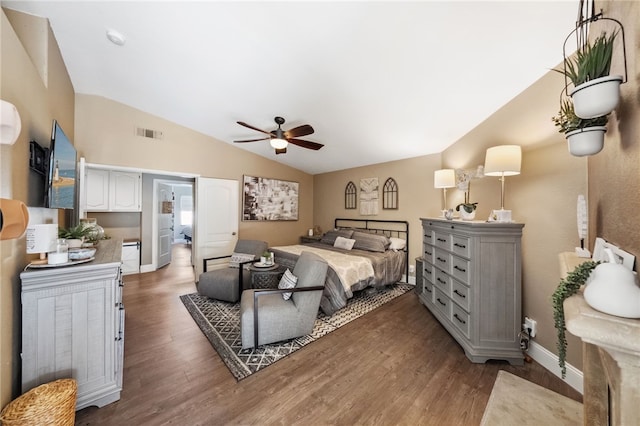 bedroom with lofted ceiling, ceiling fan, dark wood-type flooring, visible vents, and baseboards