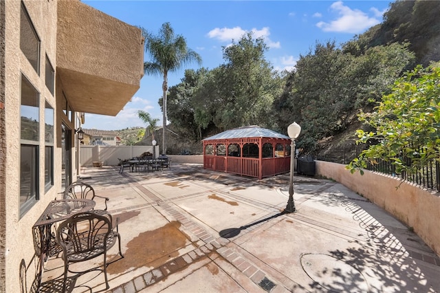 view of patio with a fenced backyard and a gazebo