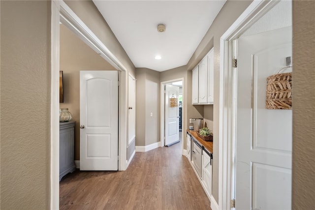 mudroom with light wood finished floors and baseboards