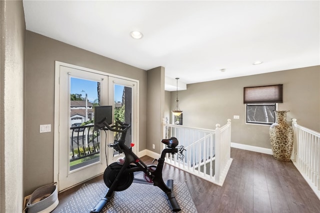 workout room featuring recessed lighting, baseboards, dark wood finished floors, and french doors