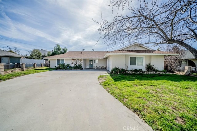 single story home featuring a garage, concrete driveway, stucco siding, fence, and a front yard