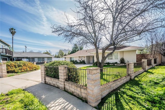 single story home featuring a fenced front yard, a front yard, and stucco siding