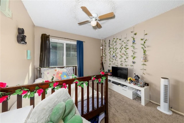 bedroom featuring a textured ceiling, carpet, a ceiling fan, and baseboards