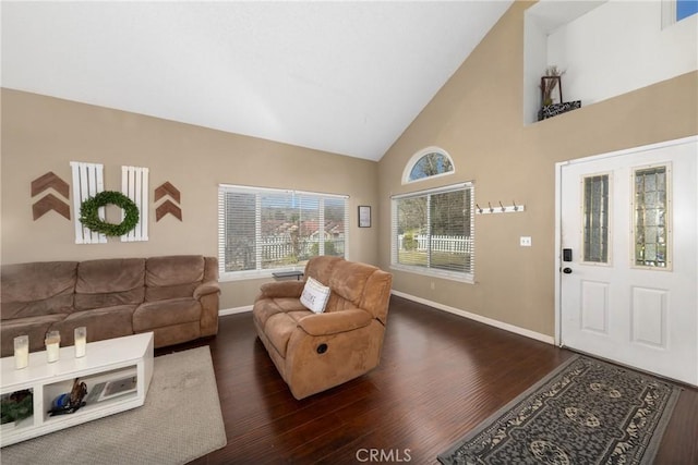 living room featuring dark wood-style floors, high vaulted ceiling, and baseboards