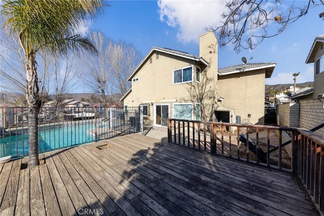 deck with fence and a fenced in pool