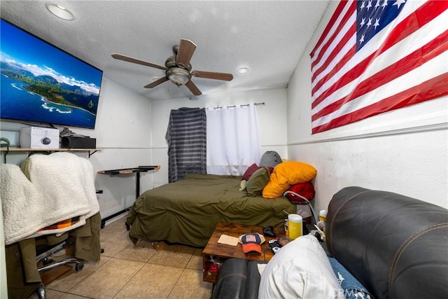 bedroom featuring a textured ceiling, a ceiling fan, and light tile patterned flooring