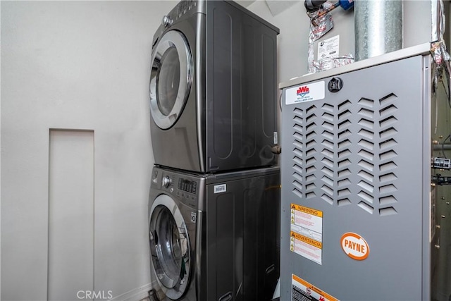 clothes washing area with laundry area and stacked washer and clothes dryer