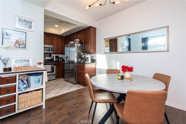 kitchen with dark countertops, light wood-style flooring, stainless steel appliances, and recessed lighting