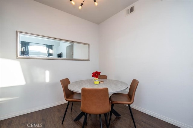 dining room with visible vents, dark wood finished floors, and baseboards