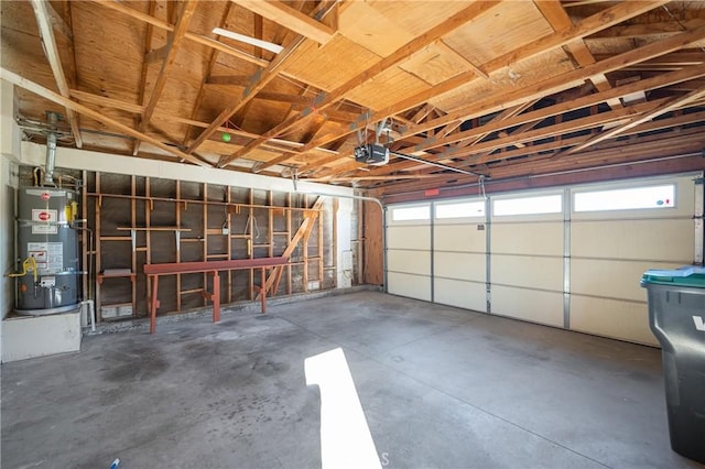 garage featuring water heater and a garage door opener