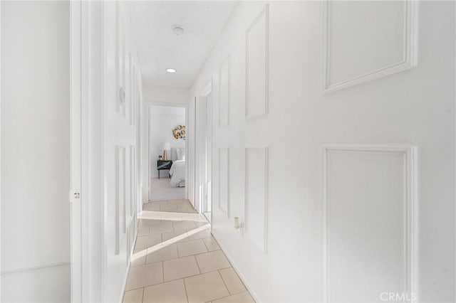 corridor featuring light tile patterned floors