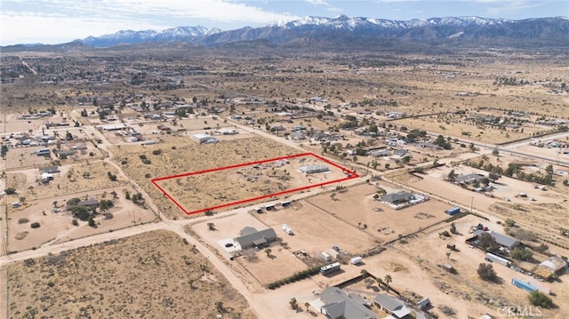 drone / aerial view featuring view of desert and a mountain view