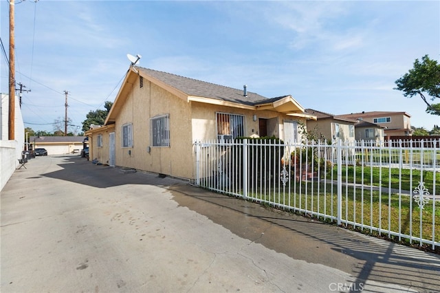 view of front of property with fence and stucco siding