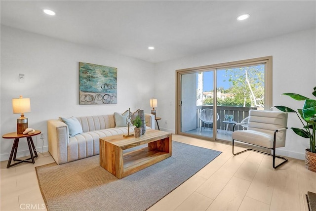 living area featuring light wood-style flooring, recessed lighting, and baseboards