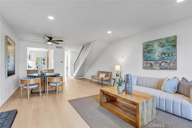 living area featuring recessed lighting, stairway, a ceiling fan, and light wood finished floors