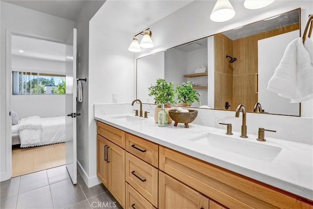 ensuite bathroom featuring tile patterned flooring, double vanity, ensuite bathroom, and a sink