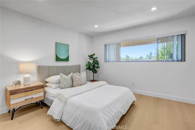 bedroom featuring recessed lighting, baseboards, and wood finished floors