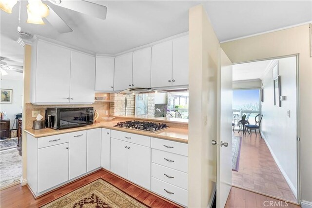 2222 Cielo Pl, Arcadia, CA 91006 - kitchen featuring black microwave, stainless steel gas cooktop, a ceiling fan, light countertops, and crown molding