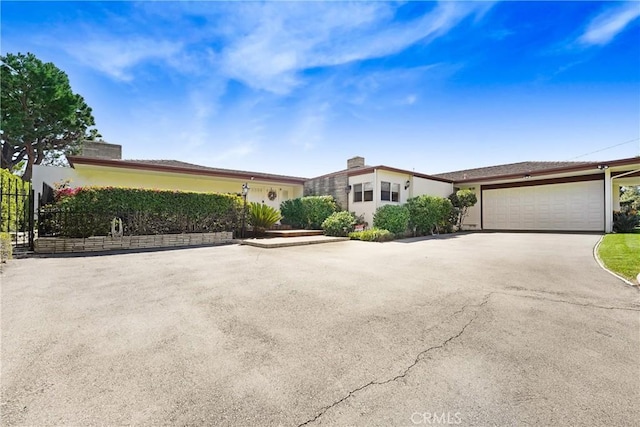2222 Cielo Pl, Arcadia, CA 91006 - view of front of home featuring stucco siding, driveway, and a chimney