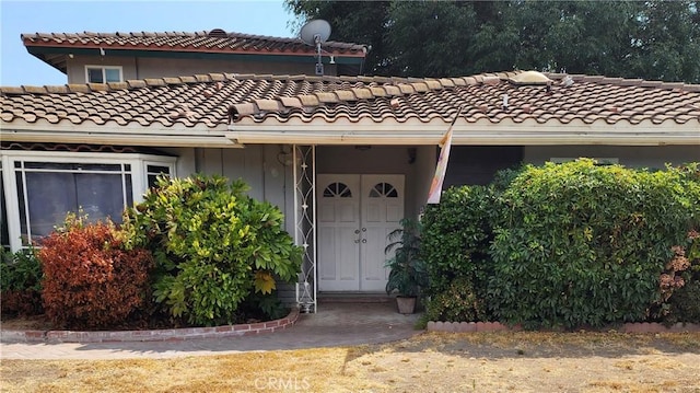 entrance to property with a tile roof