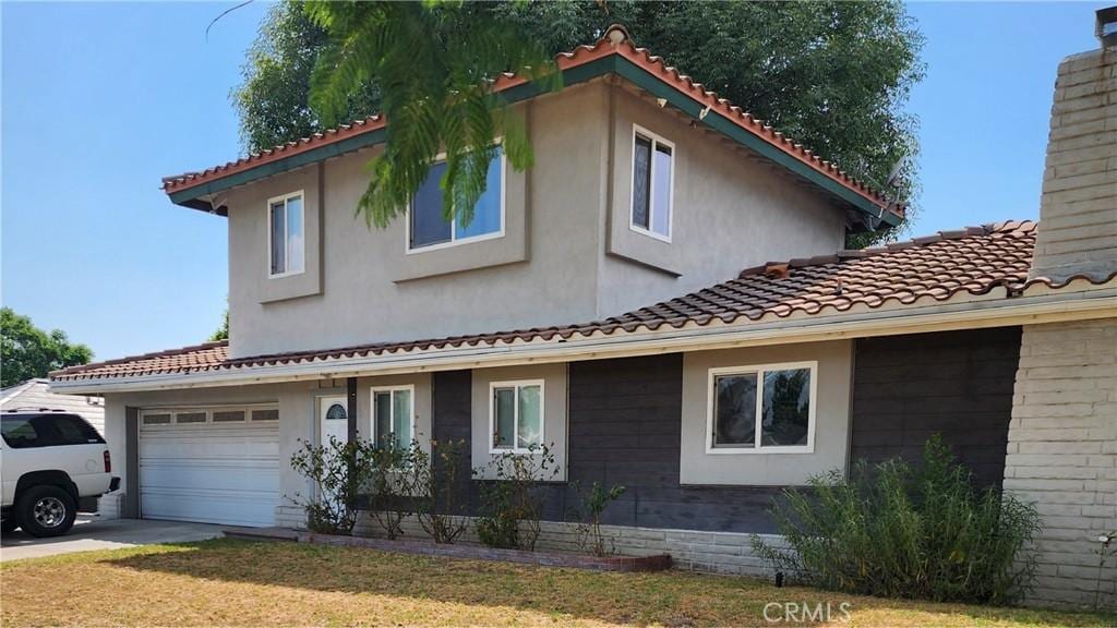 exterior space with a tiled roof, a chimney, and stucco siding