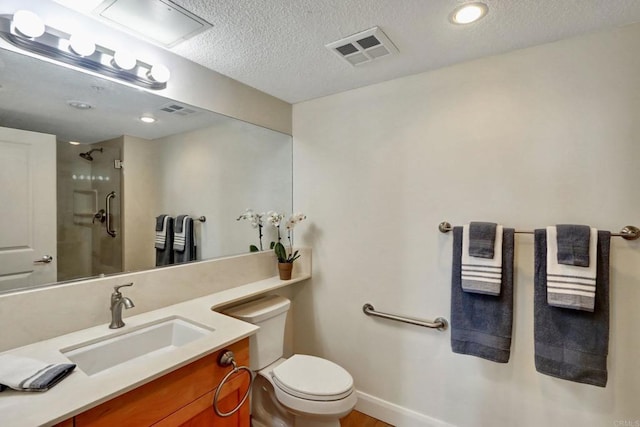 bathroom with toilet, visible vents, a shower, and a textured ceiling