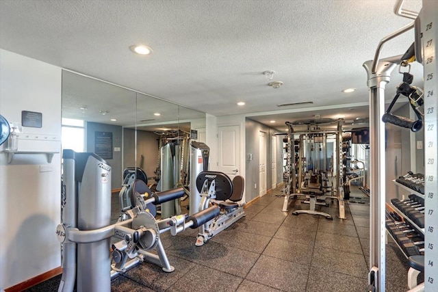 gym featuring recessed lighting and a textured ceiling