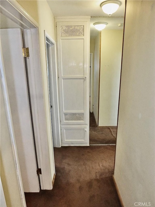 corridor with dark colored carpet and visible vents