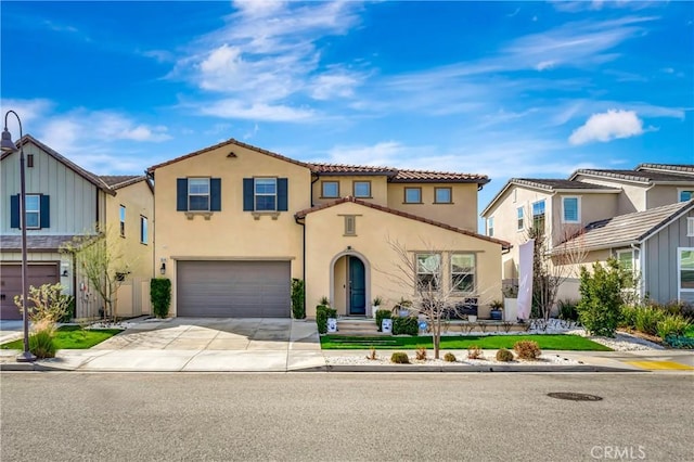 mediterranean / spanish-style home featuring a tile roof, stucco siding, an attached garage, a residential view, and driveway