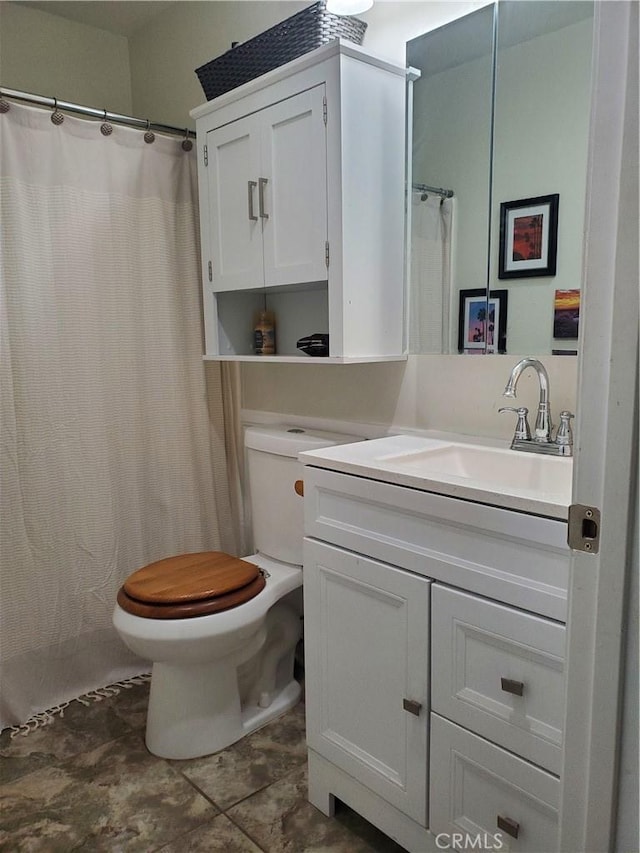 full bath with toilet and vanity