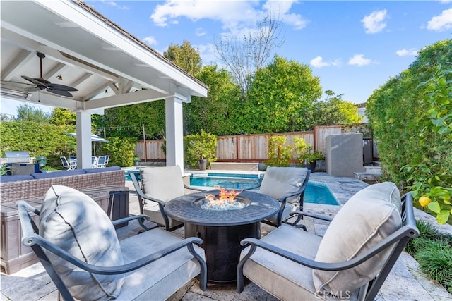 view of patio / terrace with a fenced in pool, an outdoor fire pit, a fenced backyard, and ceiling fan