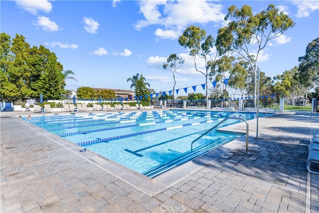 community pool featuring a patio area and fence