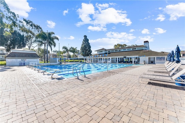 community pool featuring a patio area and fence