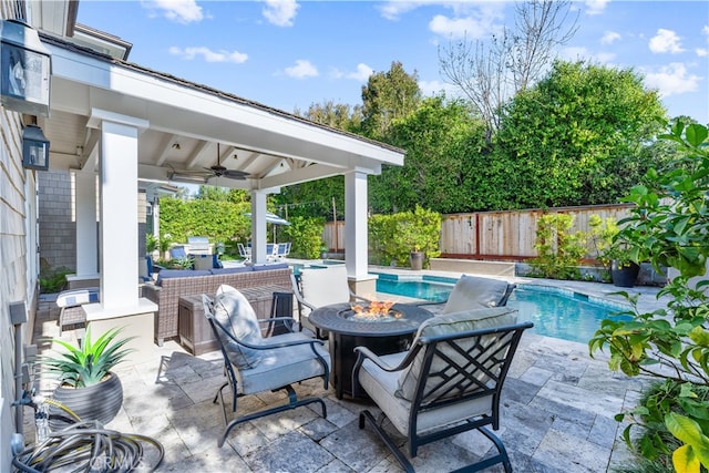 view of patio / terrace featuring a fenced backyard, a fire pit, ceiling fan, and a fenced in pool