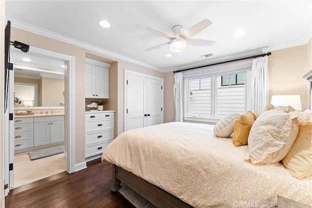 bedroom with dark wood-style floors, recessed lighting, visible vents, and crown molding