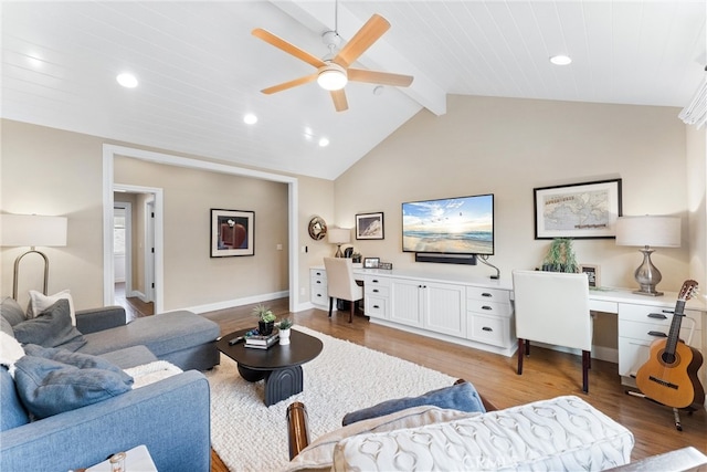 living area featuring lofted ceiling with beams, ceiling fan, recessed lighting, light wood-type flooring, and built in desk