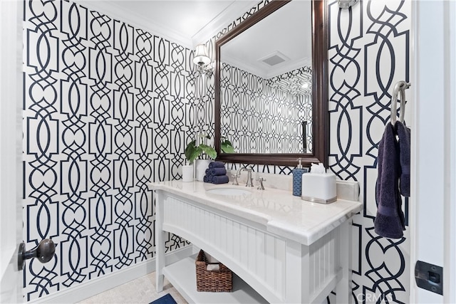 bathroom featuring visible vents, ornamental molding, and vanity