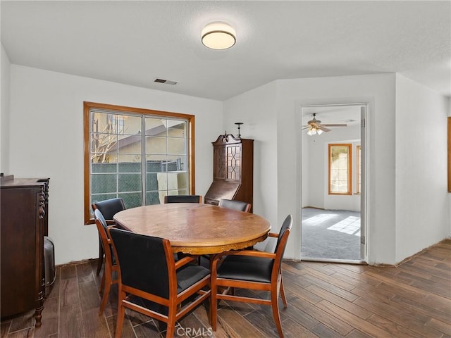 dining area featuring dark wood finished floors and visible vents