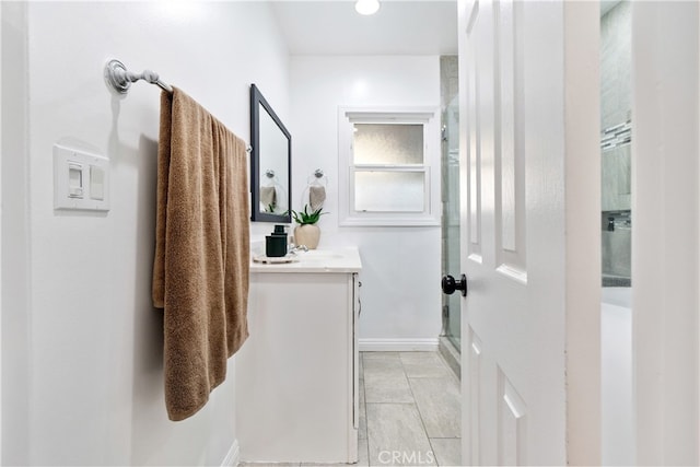 bathroom featuring a shower stall and vanity