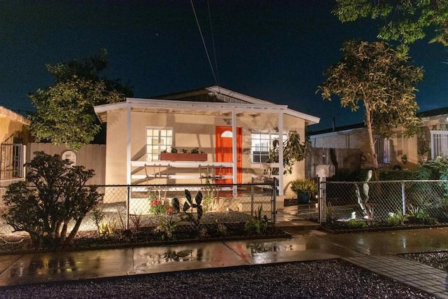 view of front facade with a fenced front yard and a gate